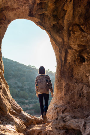 happy woman in mountains. girl traveling in the mountains. trekking and hiking. concept of sport and healthy lifestyle. girl with backpack.の写真素材