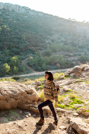happy woman in mountains. girl traveling in the mountains. trekking and hiking. concept of sport and healthy lifestyle. girl with backpack.の写真素材