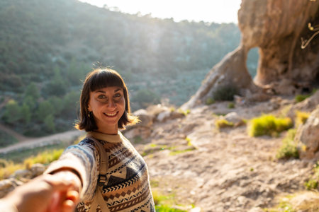 follow me. happy couple traveling. portrait of happy female tourist in mountains. girl smiling. trekking and hiking. sport and healthy lifestyle concept. girl with backpack.の写真素材