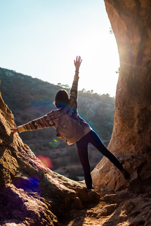 Woman in the mountains. Girl traveling in the mountains. Trekking and hiking. Sports and healthy lifestyle concept. Girl with a backpack.の写真素材