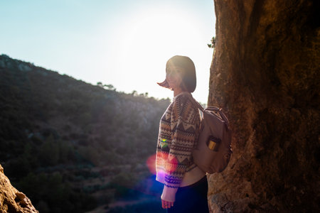 happy woman with backpack in mountains. girl smiles. trekking and hiking. Concept of sport and healthy lifestyle. girl with backpack.の写真素材