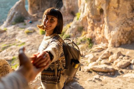 happy woman in mountains. girl traveling in the mountains. trekking and hiking. concept of sport and healthy lifestyle. girl with backpack.の写真素材