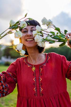 Romantic mood. Date in the park. Slender young woman with a bouquet of flowers. Girl with flowers in her hands.の写真素材