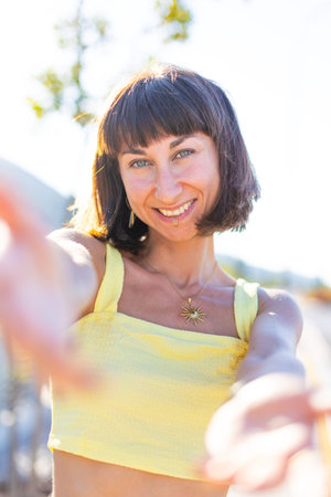 Young beautiful smiling brunette in fashionable summer yellow clothes. Seductive carefree woman...