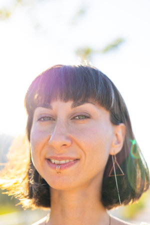 Close-up portrait of a girl. Seductive carefree woman posing outdoors on a sunny day. Young...