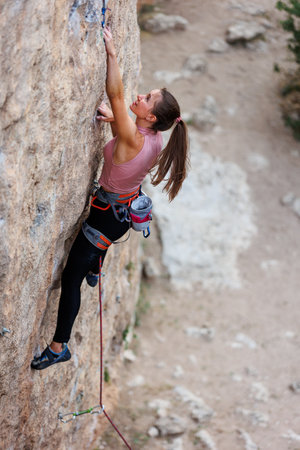 girl climber rock climber on a difficult route. sport and fitness.の写真素材