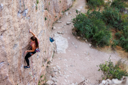 girl climber rock climber on a difficult route. sport and fitness.の写真素材