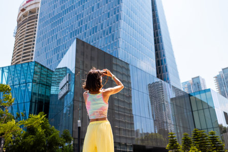 girl taking photo. Summer outdoor lifestyle, portrait of young beautiful woman having fun and enjoying vacation, traveling with camera. girl in city.の写真素材