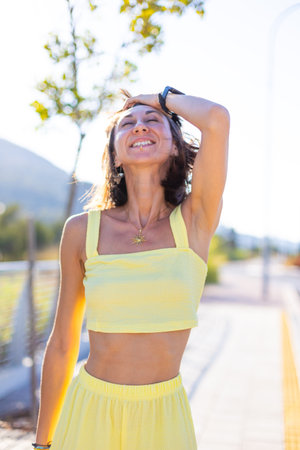 Young beautiful smiling brunette with facial piercing in fashionable summer clothes. Seductive carefree woman posing outdoors on a sunny day. Positive model outdoors. summer mood.の写真素材