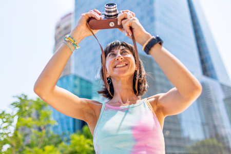 girl taking photo. Summer outdoor lifestyle, portrait of young beautiful woman having fun and...