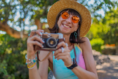 Portrait of a stylish young tourist, with a camera on the street. Stylish girl with a film camera...