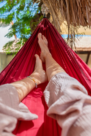 girl rest enjoying in hammock. close-up focus on legs. concept of romantic carefree mood. summer mood.の写真素材