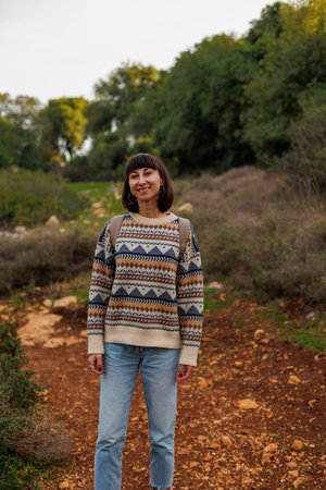 Portrait of a tourist on the mountain and enjoying freedom. Adventure and hike. Young happy female...
