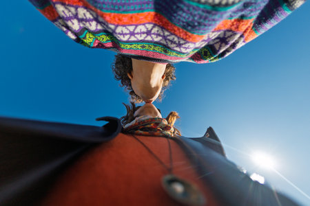 Young couple kissing against the background of a beautiful sky. Date on the beach. Love and relationship concept.の写真素材