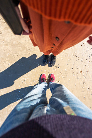 girl and boy holding hands. walk on the beach. travel and vacationの写真素材