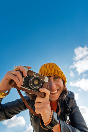 young girl with a camera. photographer with camera. Stylish girl with a film camera. takes a shot. adventures and travel.の写真素材