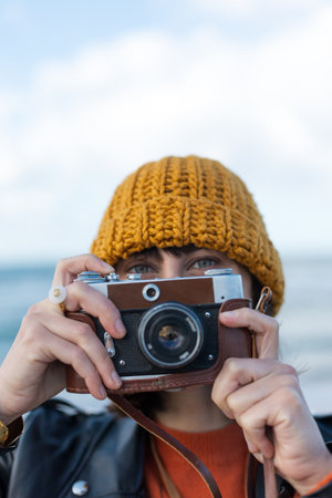 young girl with a camera. photographer with camera. Stylish girl with a film camera. takes a shot. adventures and travel.の写真素材