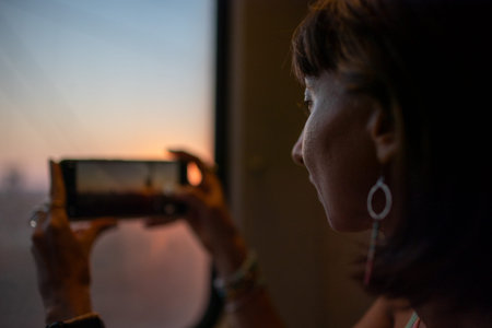 Young woman travels by train and creates content for social networks. Girl takes photos from the...