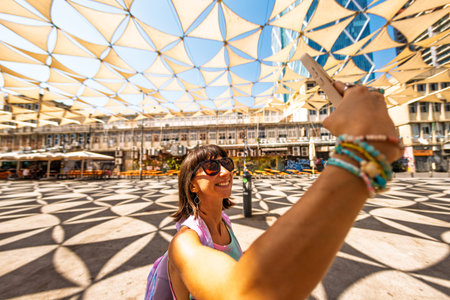 Stylish girl blogger creates content for Social Media. Walking around Tel Aviv. Travel to Israel.