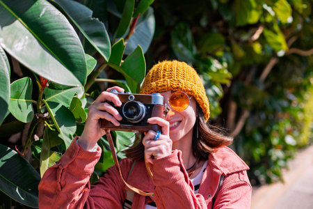 Girl with a camera. A young tourist travels around the city and films the sights on camera. The girl...