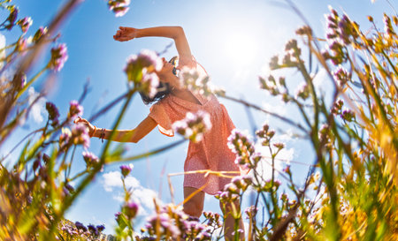 Summer lifestyle portrait of a beautiful young brunette in a summer pink dress. Romantic mood....