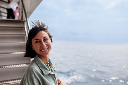 Vacation on a cruise ship. A woman is on vacation on a cruise ship, enjoying the trip.の写真素材