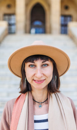 portrait of a cheerful white woman in a hat. Travel to interesting places. Photo of a fashionable...