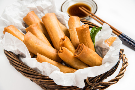 Traditional Asian Fried Spring Rolls with Dipping Sauce on White Backgroundの写真素材