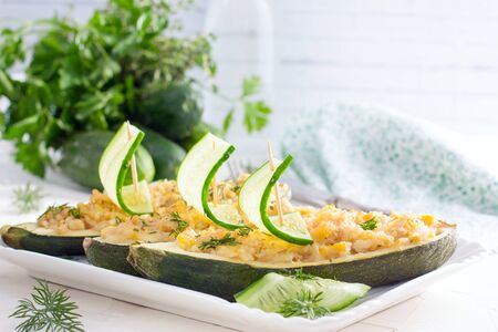 Zucchini stuffed with rice and chicken, decorated with fresh cucumber. Festive menu, horizontalの写真素材