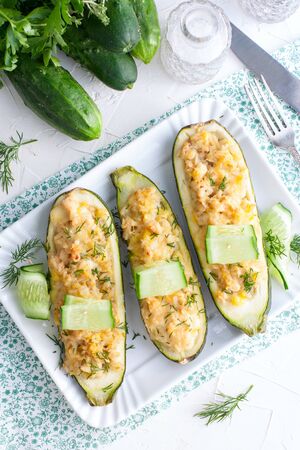 Stuffed halves of courgettes with chicken meat and brown rice, selective focus, top viewの写真素材