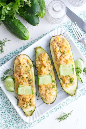 Stuffed halves of courgettes with chicken meat and brown rice, selective focus, top viewの写真素材