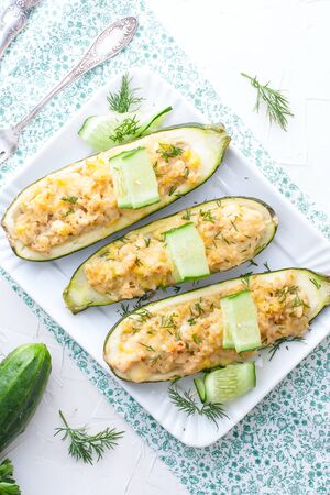 Stuffed halves of courgettes with chicken meat and brown rice, selective focus, top viewの写真素材