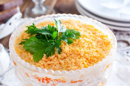 Salad with chicken and carrots in a crystal salad bowl on the festive table, horizontalの写真素材