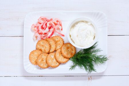 Cooking canapes with shrimp, salted crackers, cream cheese, fresh dill, top viewの写真素材