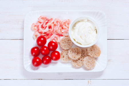 Cooking canapes with shrimp, cherry tomatoes, cream cheese and bread, top viewの写真素材