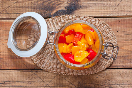 Step-by-step preparation of pickled bell pepper, step 5 - laying of the finished pepper in glass jars for storage, top view, horizontalの写真素材
