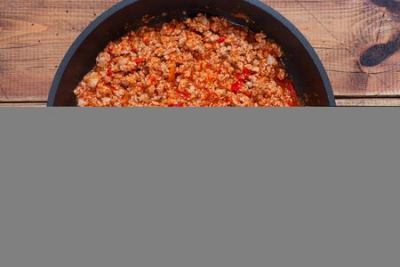 Step-by-step preparation of stuffed cannelloni with bechamel sauce, step 4 - preparation of bolognese sauce, top view, horizontalの写真素材