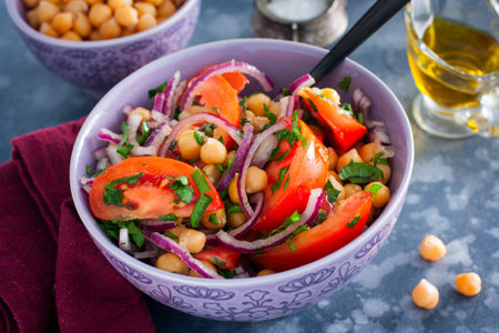 Salad with tomatoes, chickpeas and red onions, selective focusの写真素材