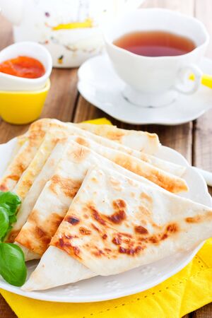 Envelopes in the form of a triangle of pita bread stuffed with cheese and herbs, selective focusの写真素材