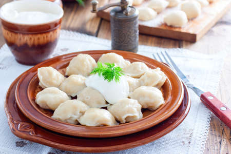 Traditional homemade Russian dumplings cooked in dumplings, selective focusの写真素材
