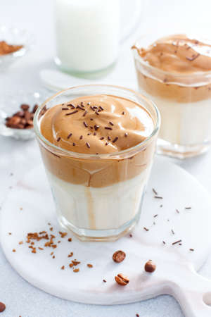 Cold Dalgon coffee in a glass on a white background. A trendy drink made from whipped instant coffee and milk. Close up.の写真素材