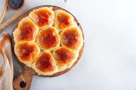 Round yeast dough buns stuffed with ham and cheese, pizza in bun, selective focusの写真素材
