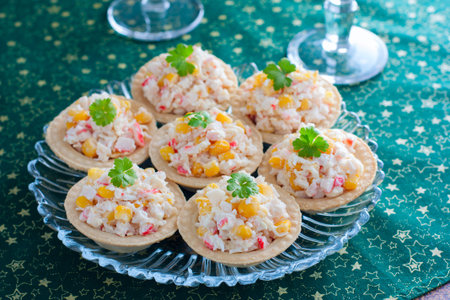 Celebratory tartlets with crab salad and corn on a glass dish and glasses of champagne, horizontalの写真素材