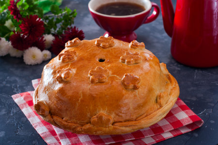 Festive traditional Russian pie kurnik with pancakes, mushrooms, chicken, horizontalの写真素材