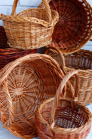 Handmade willow wicker baskets with two handles, one handle, no handles on the table, selective focusの写真素材