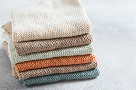 Kitchen napkins knitted from natural cotton of different colors on a white table, selective focus,...