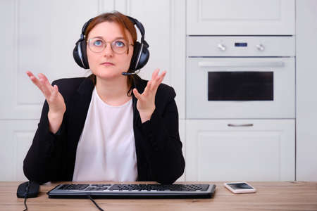 A woman asks for help from above while working online. Problems with Internet training and the difficulty of working from home during the flu virus epidemicの写真素材