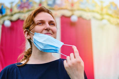 A woman near the circus took off her medical mask ahead of the opening of public events and holidaysの写真素材