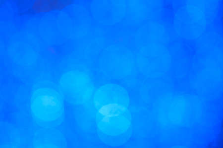 Blurred abstract background, bokeh of blue circles close-upの写真素材