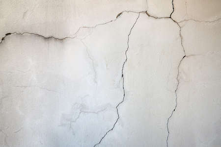 Background of old concrete wall with cracks, texture of cracked cement surface, copy spaceの写真素材